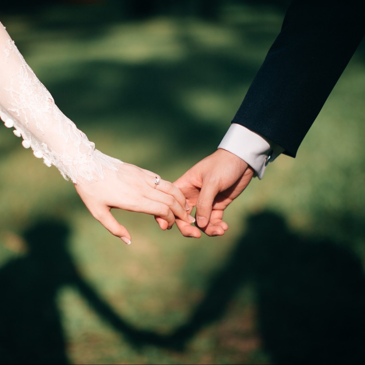 man and woman holding hands focus photo